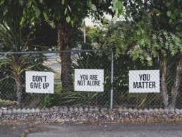 Encouraging signs on a fence